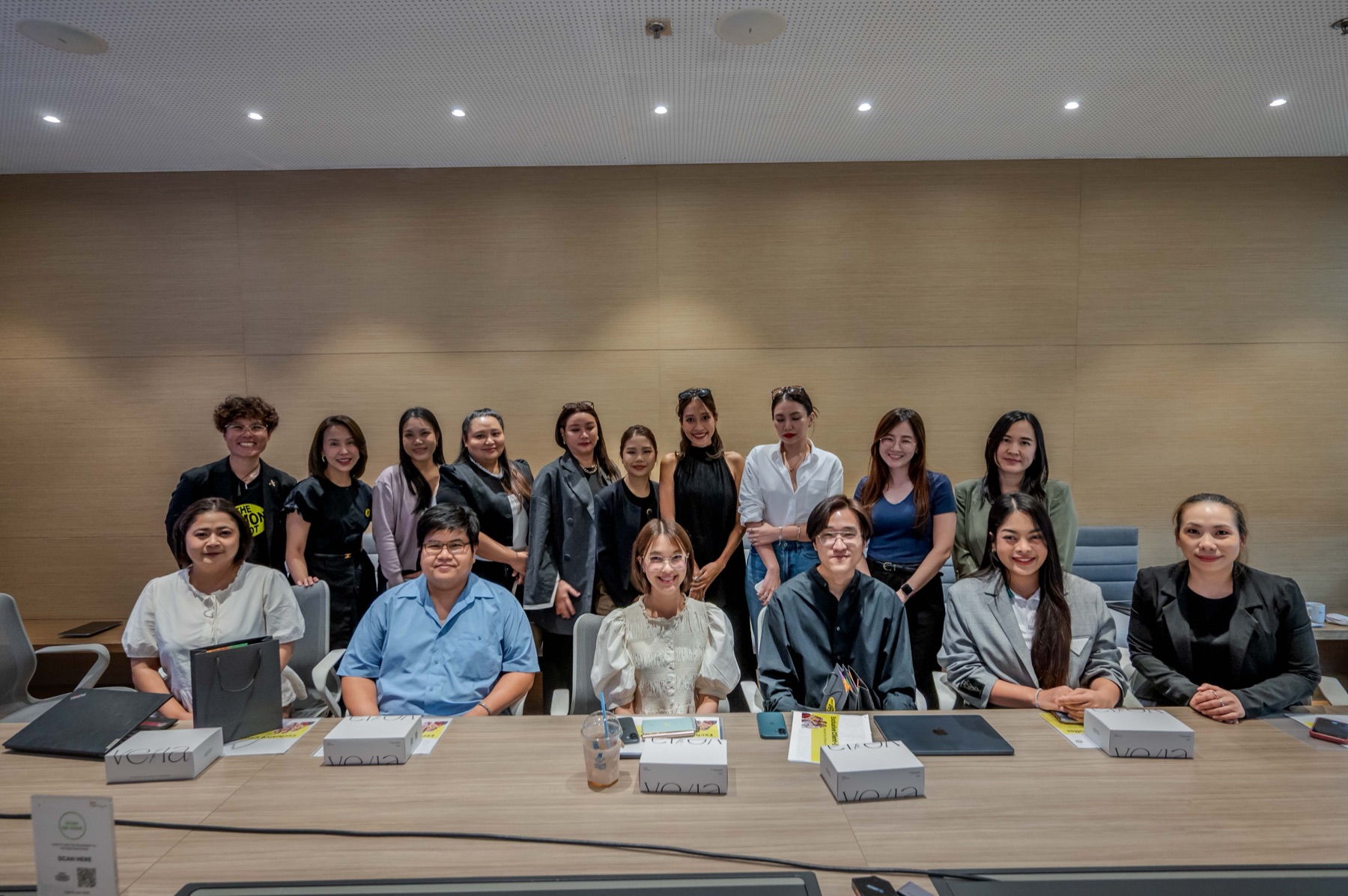 A group photo at the end of a brand strategy workshop, product boxes on the table