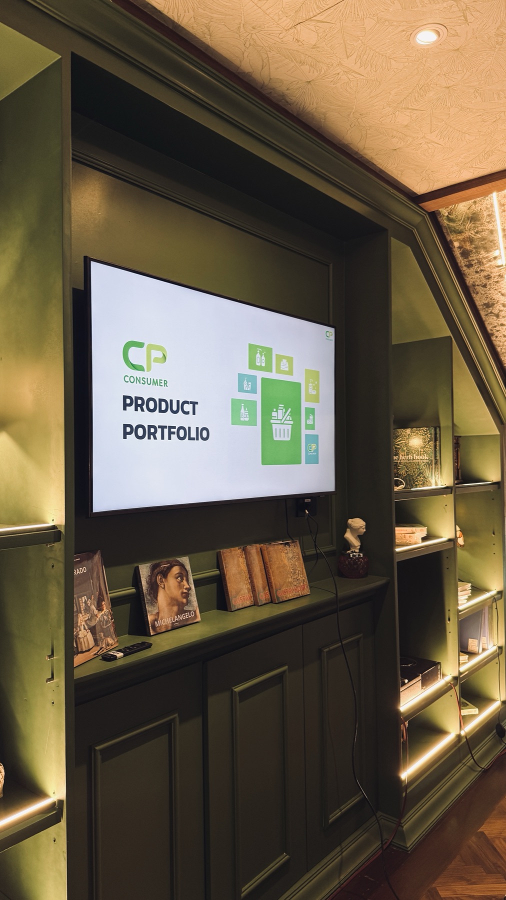 A branded 'CP Consumer Product Portfolio' screen in a private meeting lounge